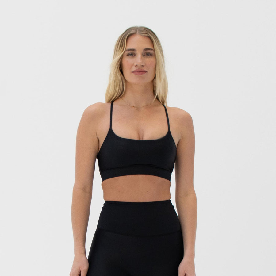 Black scoop neck sports bra made from recycled plastic bottles