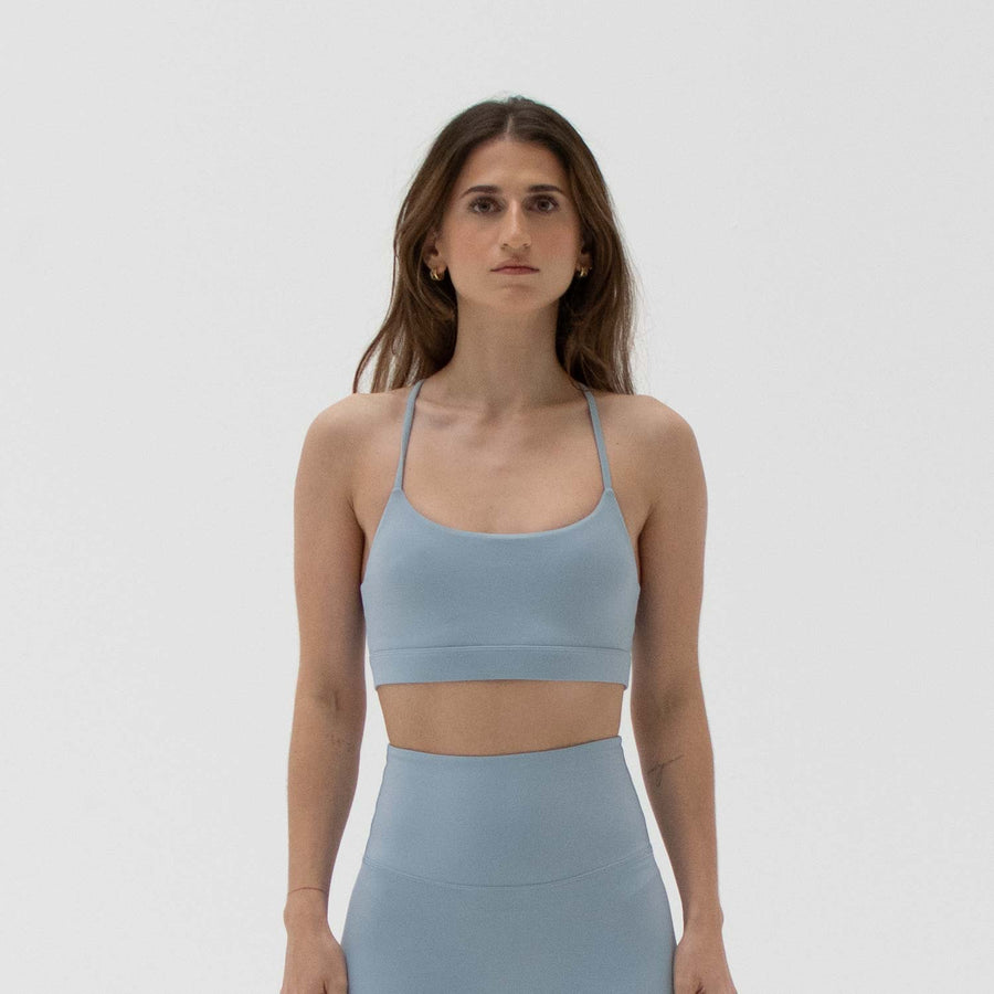 Blue scoop neck sports bra made from recycled plastic bottles